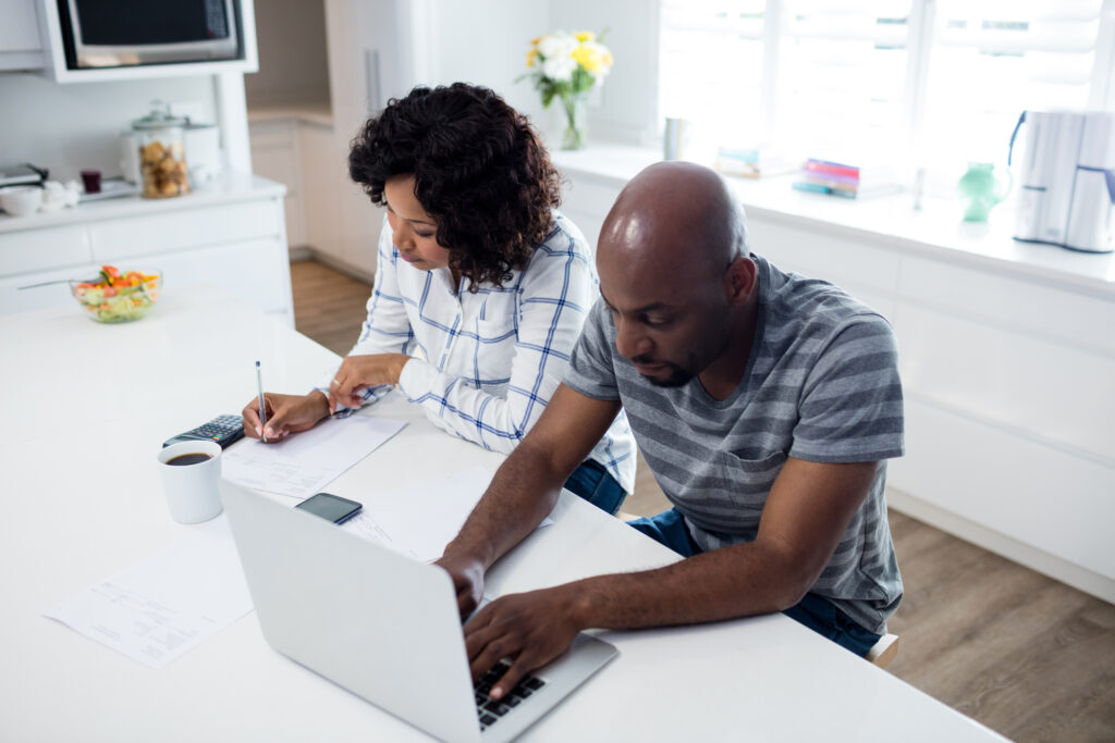 Couple checking bills worriedly 